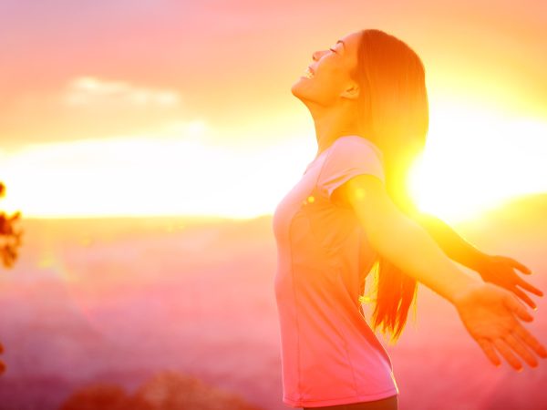 Free happy woman enjoying nature sunset. Freedom, happiness and enjoyment concept of beautiful multiracial Asian Caucasian girl in her 20s. Image from Grand Canyon, United States.